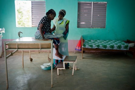 Sayon Keita, who is pregnant with her seventh child, is examined by a midwife at a health post near Doko, Siguiri