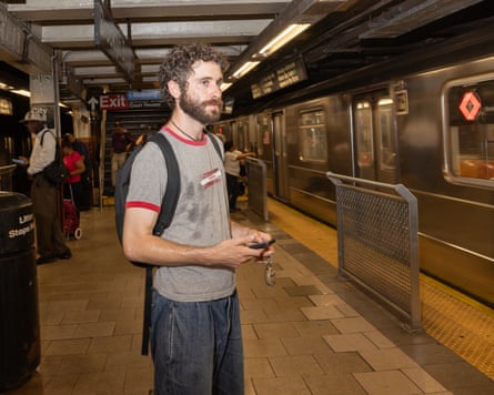 Jack Klein standing on the NYC subway beside a train.