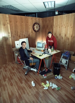 Google co-founders Larry Page (wearing red Stanford sweatshirt) and Sergey Brin posing in a messy office setting on October, 2002 in Mountain View, California.