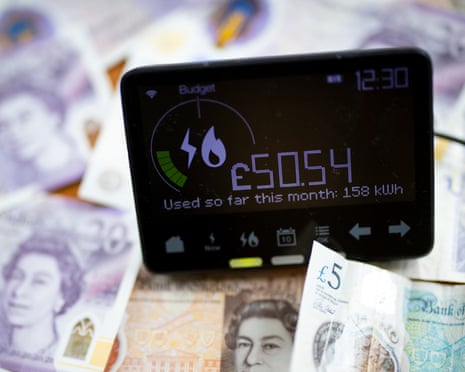 A smart energy meter on top of £5, £10, and £20 notes in a home