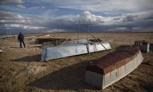 A fisherman walks among boats abandoned along the shore of the dried up Lake Poopó in this photo dated 11 January.