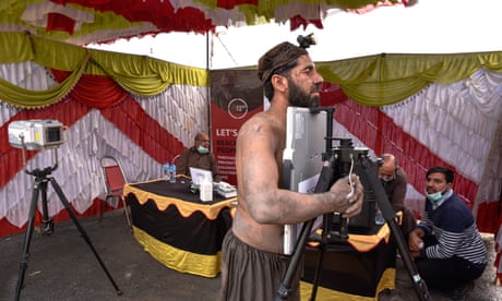 A miner is screened for TB in a tent