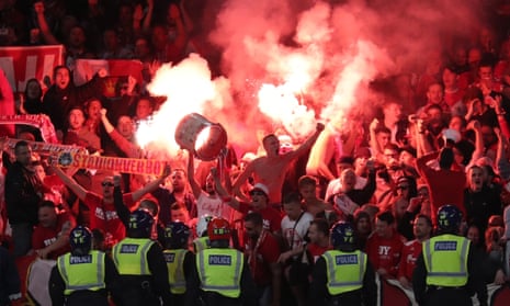 Cologne supporters ignite flares during the Europa League tie with Arsenal at the Emirates Stadium.