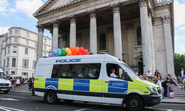 A police van carries rainbow balloons at Pride in London.