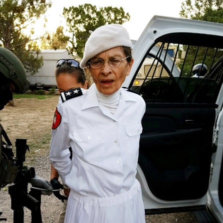 Deborah Green, leader of the Aggressive Christianity Missions Training Corps. She is wearing a white beret, white shirt and white polo neck.