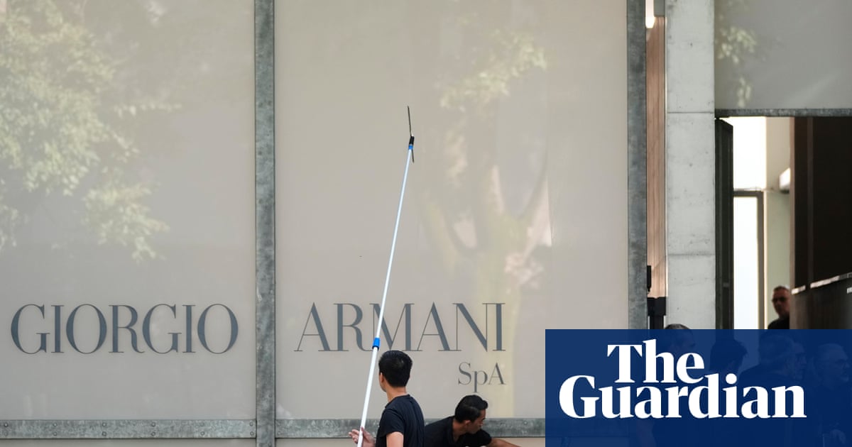 Crowds gather outside Giorgio Armani's Milan HQ to pay respects before funeral
