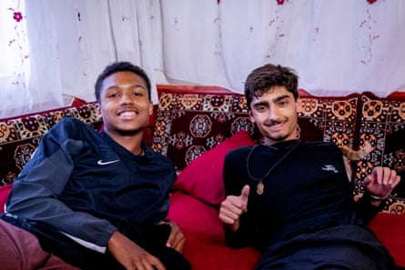 Two young men relaxing on a banquette