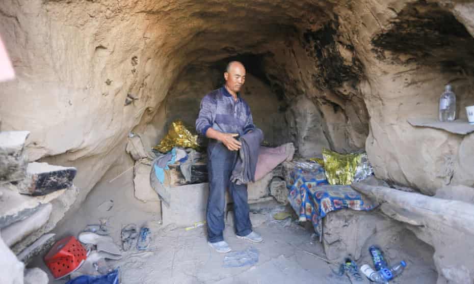 Zhu Keming in the cave where he sheltered the runners. which he had previously stocked up with food and clothes for emergencies.