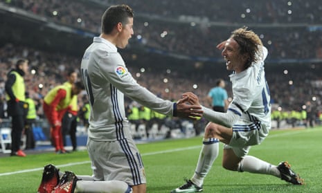 James Rodríguez celebrates with Luka Modric after scoring Real Madrid’s third goal against Sevilla before half-time in the first leg of the Copa del Rey tie.