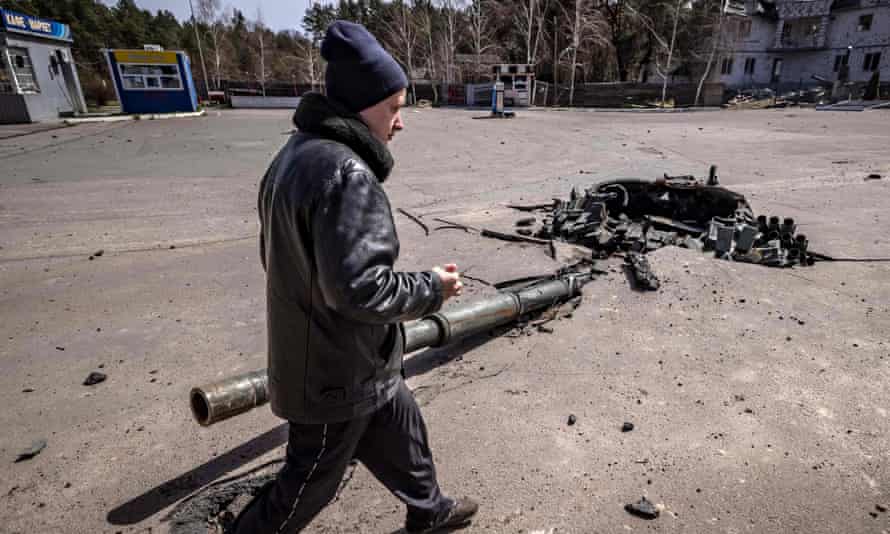 A man walks next to a turret of a destroyed tank near Zalissya, northeast of Kyiv, April 14, 2022.