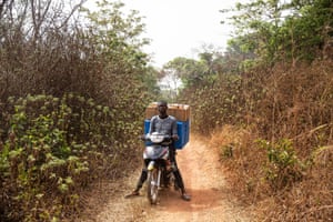Sodea Mathurin drives a motorbike carrying a fresh supply of vaccine from Baboua to Ndongue village. Central African Republic