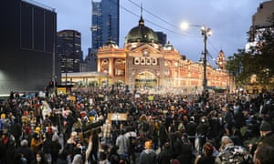Protestors listen to speeches as night falls at the Melbourne Black Lives Matter protest