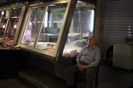 Negotiations between Greek Government and its lenders continue in Brussels<br>epaselect epa04836746 A man sits next to a product stand at the meat market in Athens, Greece, 08 July 2015. The eurozone’s bailout fund, the European Stability Mechanism (ESM), said that it has received a request from Greece for a new aid package. EPA/FOTIS PLEGAS G.