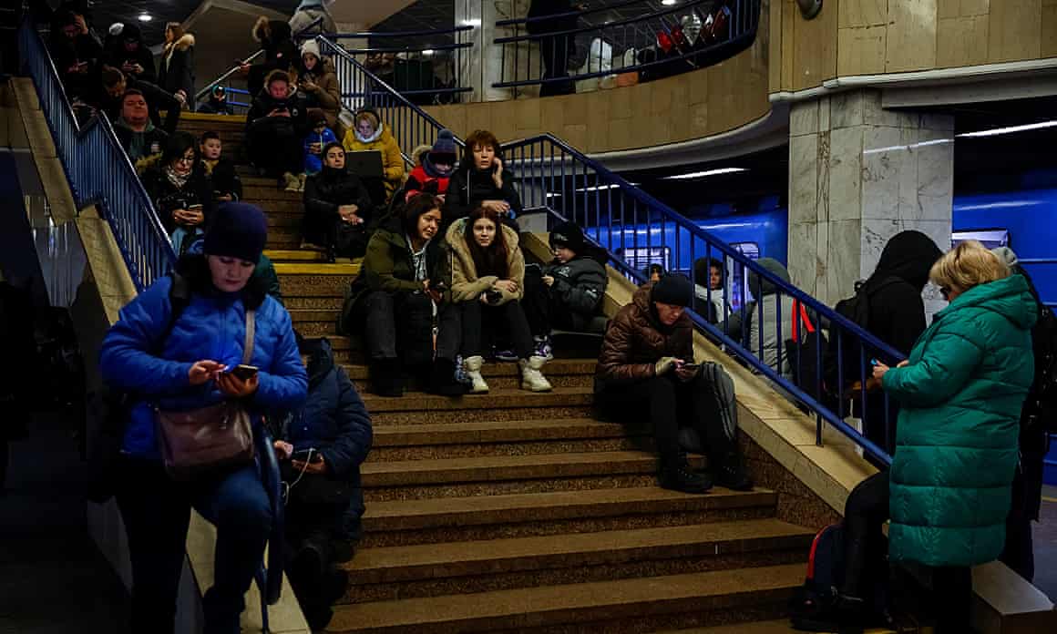 People take shelter inside a Kyiv metro station