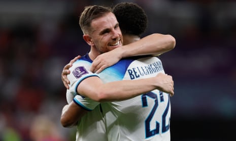 England midfielders Jordan Henderson and Jude Bellingham embrace after the win against Wales