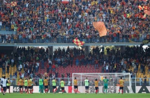 Lecce players celebrate in front of fans after the match.