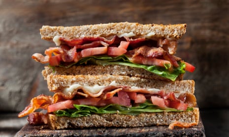 A toasted bacon sandwich with lettuce and tomato.