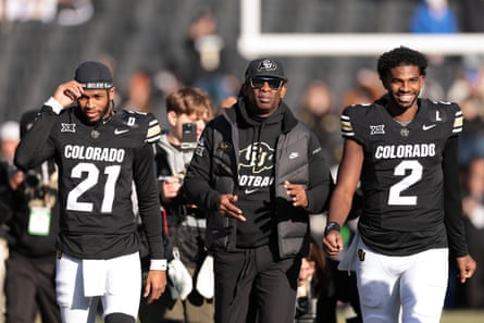 Shilo Sanders (21), Colorado head coach Deion Sanders and Shedeur Sanders (2) walk on the field during senior day celebrations prior to the game against the Oklahoma State Cowboys at Folsom Field in November.