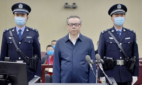 Lai Xiaomin in the dock with two officers