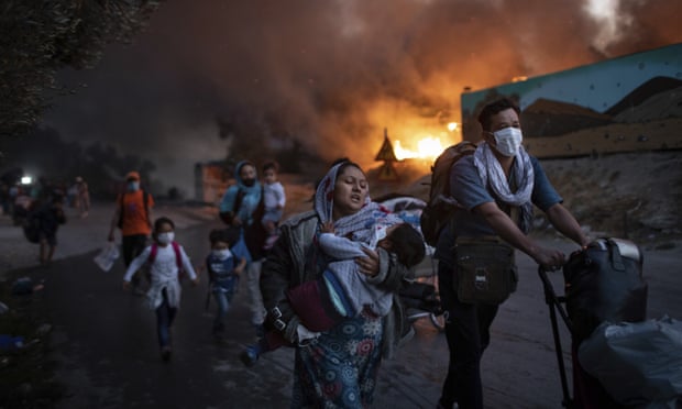 Migrants flee from the fire that destroyed the Moria camp on Lesbos in September 2020