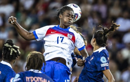 Michelle Agyemang, left, contests a header against France