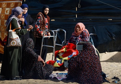 A group of Palestinian women together, one of whom is in a whelchair