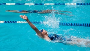 Girl doing backstroke in swimming pool