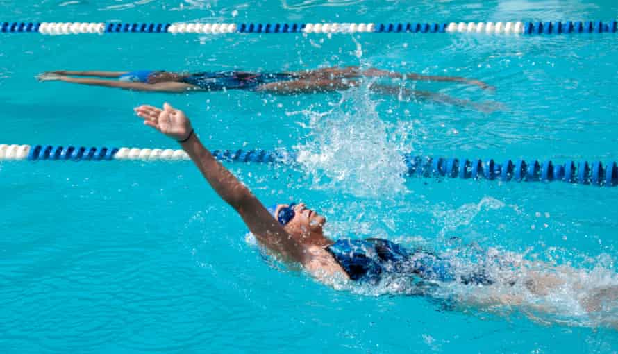 Girl doing backstroke in swimming pool