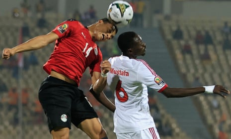 Egypt’s Mostafa Mohamed beats Sudan’s Mustafa Karshoum in the air.