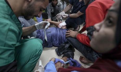 Medical staff and injured Palestinians at the al-Aqsa Martyrs hospital, Deir al-Balah, Gaza, 24 November 2023.