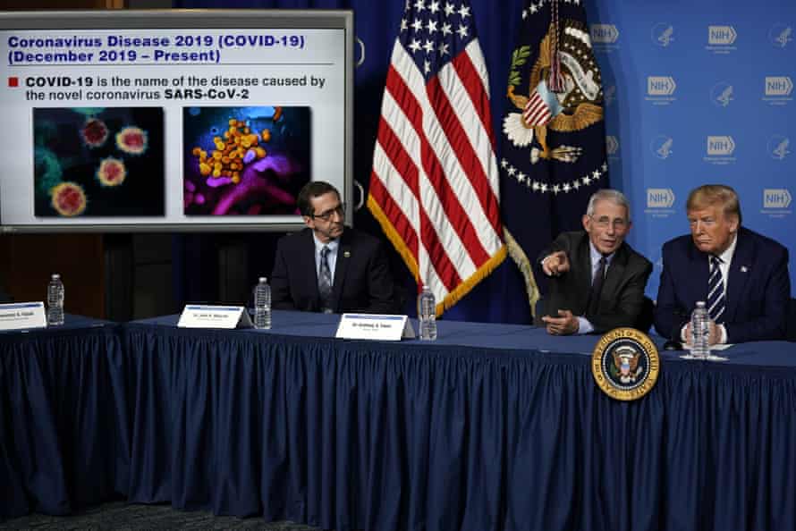 Donald Trump listens to Dr Anthony Fauci, director of the National Institute of Allergy and Infectious Diseases, during a briefing on the coronavirus.