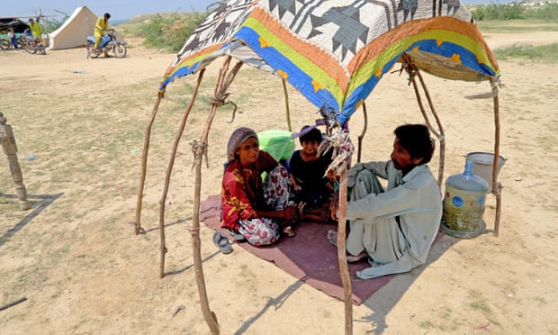 An internally displaced family sit in a makeshift tent after heavy monsoon rains in Sindh province. Pakistan.