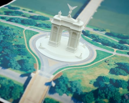 A model of a white arch with photos of grass and trees around it