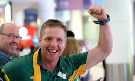 A Socceroo fan cheers the players as they arrived at Sydney airport.