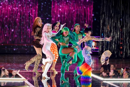 The Jellicle Ball perform on stage behind a glittering purple backdrop