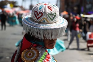 a person dressed in vibrant traditional attire, participating in the Virgin of Carmen parade in La Paz, Bolivia.