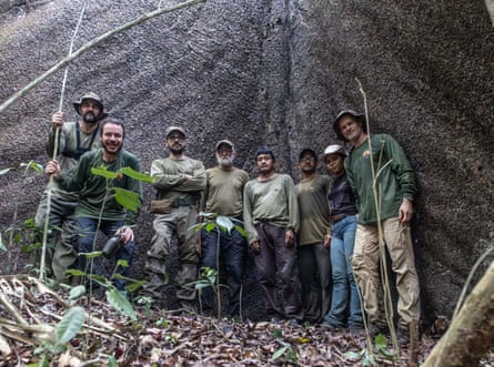 Eight people, seven men and a woman, line up for a photo on the Funai Kawahiva expedition in Mato Grosso state, Brazil.