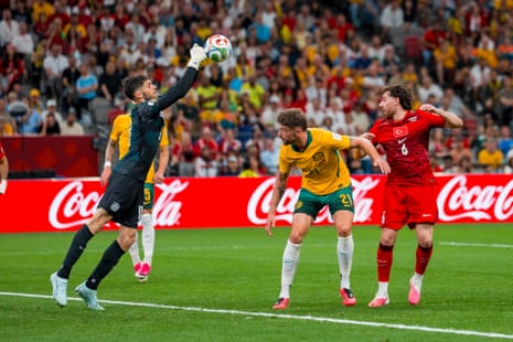 Patrick Beach (L) of Australia makes a save