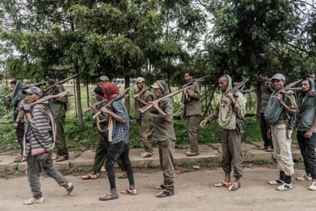 Amhara militia members walk through a rural area near the village of Dabat, 70km north-east of Gondar, Ethiopia.