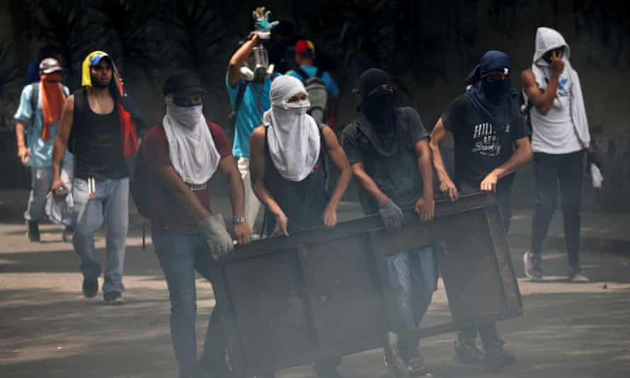 Demonstrators build a barricade while clashing with riot police during the so-called ‘mother of all marches’ in Caracas, Venezuela on Wednesday.