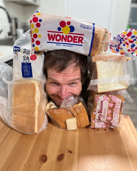 man’s head is surrounded by different brands of bread