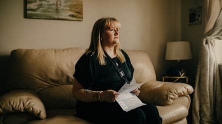 Julie-Anne Kearns sitting on a sofa holding a letter