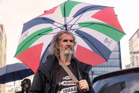 John Nicholson, carrying an umbrella John Nicholson, carrying an umbrella