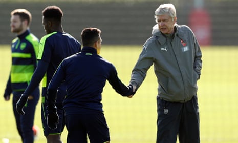 Arsène Wenger shakes hands with Arsenal’s Alexis Sánchez as Arsenal prepare for their Champions League tie against Bayern Munich.