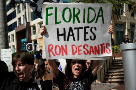 Protesters gathered on Wednesday outside the Four Seasons Hotel in Miami, Florida, as Ron DeSantis was expected to publicly announce his run for president.