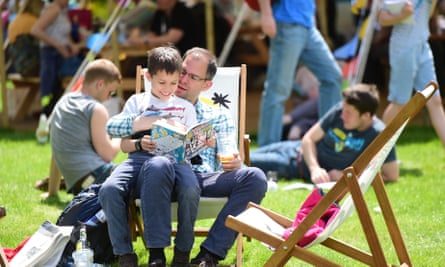 A parent reading to his son at the Hay literature festival in 2015.