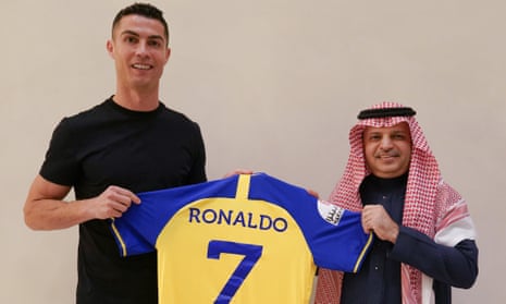 Cristiano Ronaldo poses with his shirt after agreeing a move to Al-Nassr.
