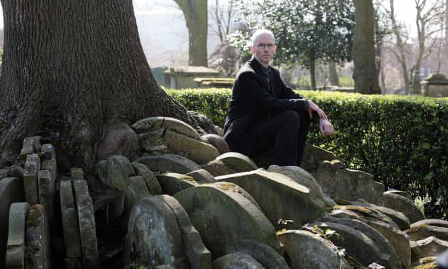 Jon McGregor by the ‘Hardy tree’ in St Pancras graveyard, London, growing from gravestones moved while Thomas Hardy worked there.