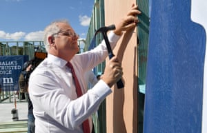 Australian Prime Minister Scott Morrison is seen hammering a nail during a visit to a building site at Geebung in Brisbane, Tuesday, May 18, 2021.