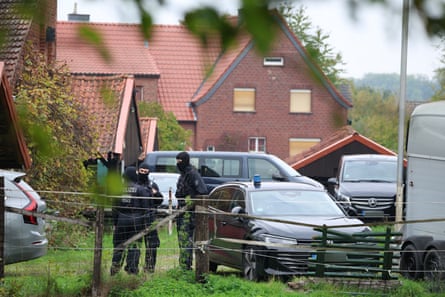 Masked police officers outside Hanning’s home.